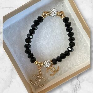 Elegant Black and Gold Bracelet with Charm